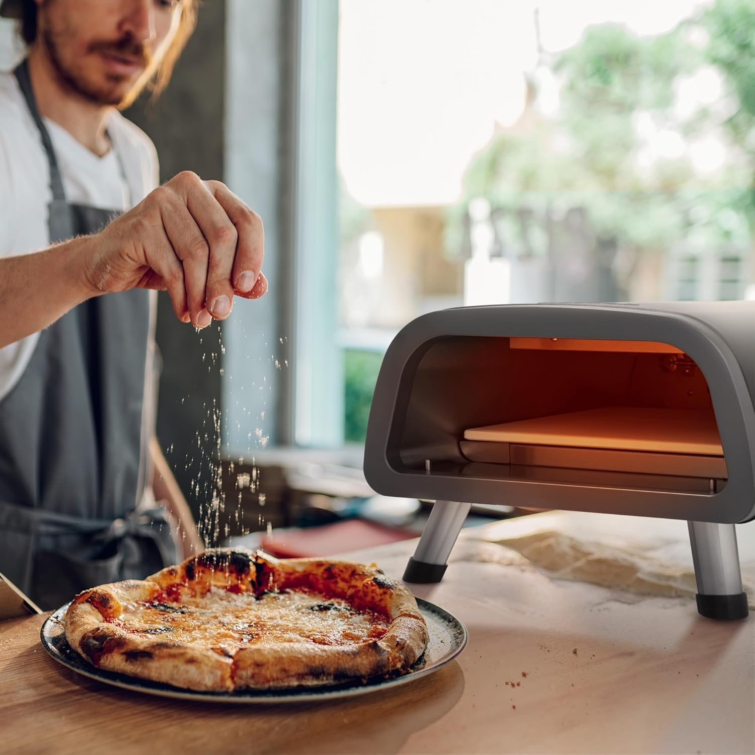 image:imageNewair 12 Portable Electric Pizza Oven 900F Countertop Pizza Maker for Indoor amp Outdoor Use Dual Heating Elements Foldable Legs amp Pizza Stone